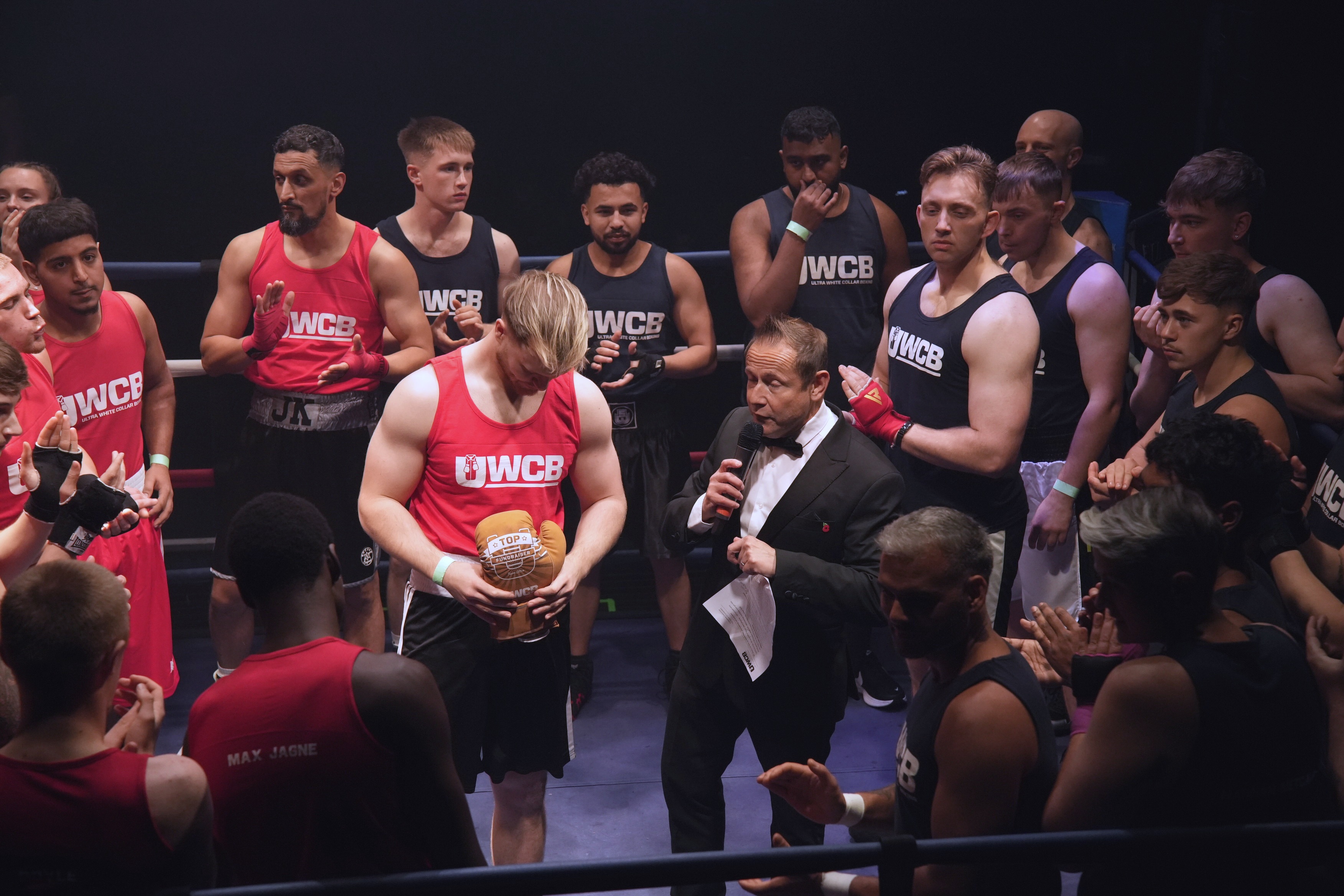 Nick Mummery presenting a winner inside the boxing ring